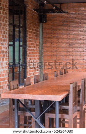 set wooden table with brick wall
