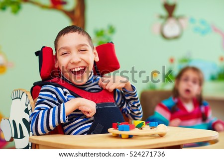 cheerful boy with disability at rehabilitation center for kids with special needs Royalty-Free Stock Photo #524271736