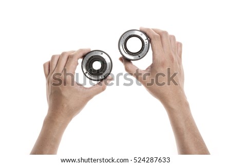 A man hand hold a vintage(old) camera lens isolated white.