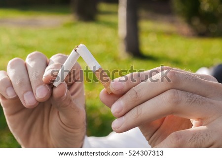 Gesture for quit smoking, Anti Smoking,  male hand crushing cigarette, Non Smoker. man has decided to stop smoking.