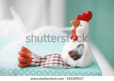 the symbol of the new 2017 rooster on turquoise background, Christmas gifts