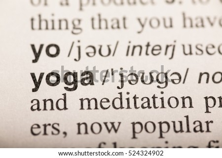 yoga - word in dictionary. macro shot. selective focus