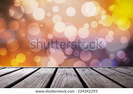 wood table in front of glitter silver and gold bright bokeh lights. For product display