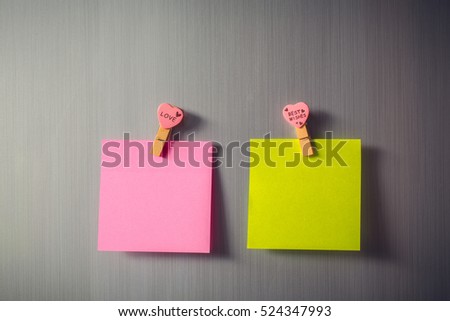 Abstract of wooden heart clip with Blank paper and stick paper on refrigerator door. paper note copy space for add text. valentine picture message background

