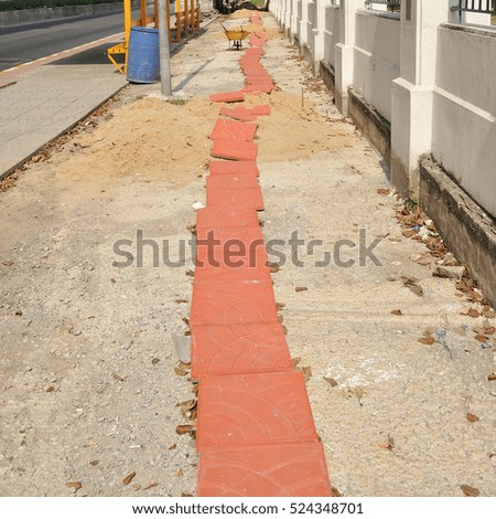 Red block prepare for footpath sidewalk pavement under construction.