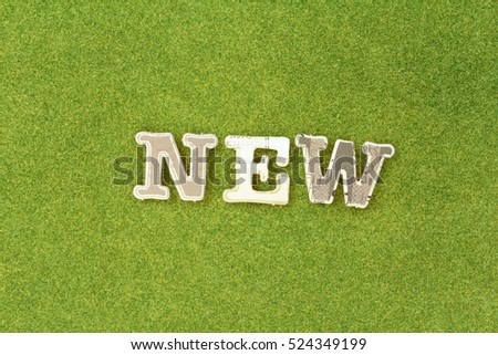 new: paper cut alphabet on green grass