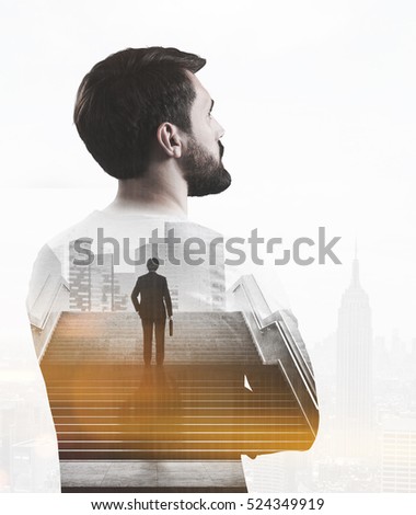Rear view of a bearded businessman in white shirt. A picture of a man holding a suitcase and standing on the stairs in a city is in the foreground. Toned image. Double exposure.