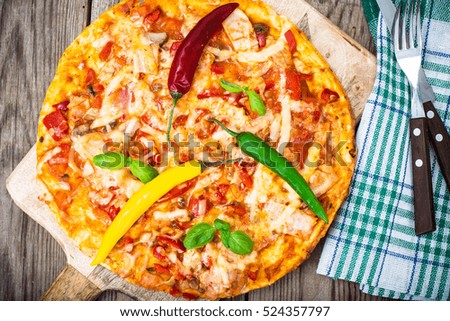 Pizza with prosciutto,mushroom and tomatoes. Studio Photo