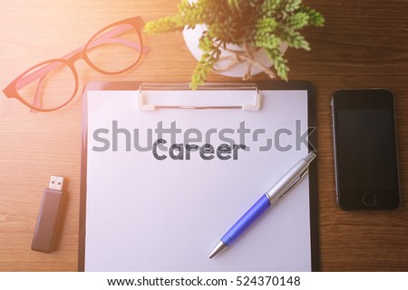 Office desk with a paper written Career with pen, glass, smartphone and a thumb drive
