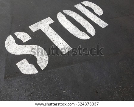 Stop sign on asphalt, detail of a road sign