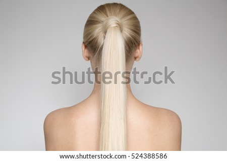 Portrait Of A Beautiful Young Blond Woman With Ponytail Hairsty?le. Back view Royalty-Free Stock Photo #524388586