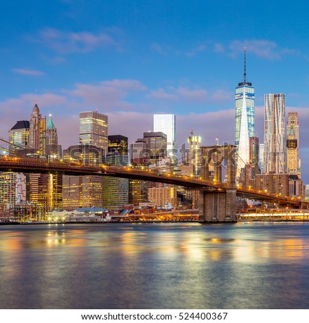 Sunrise view of  Brooklyn Bridge and Lower Manhattan skyline in New York City with city illumination, USA