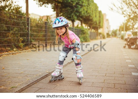 Young happy skater trying exciting outdoor activity