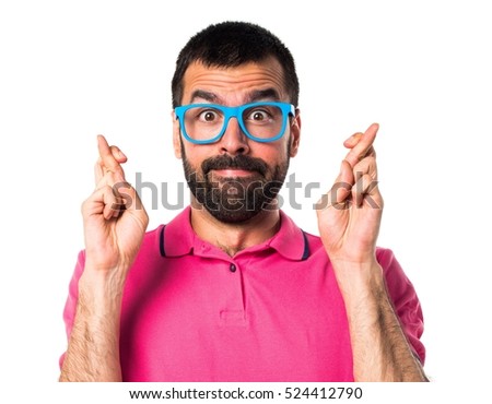 Man with colorful clothes with his fingers crossing