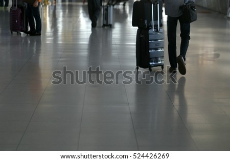 Soft focus of traveler walking with trolley bag