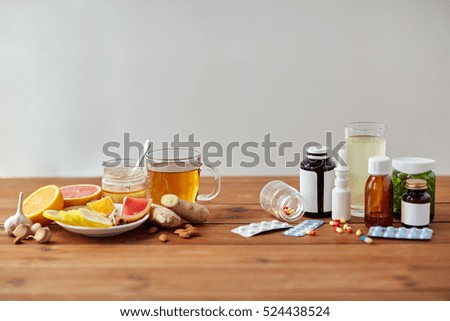 health, traditional medicine and ethnoscience concept - natural and synthetic drugs on wooden table Royalty-Free Stock Photo #524438524