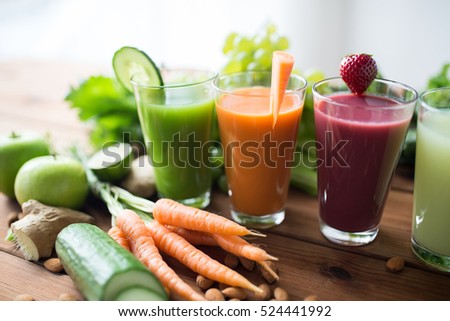 healthy eating, drinks, diet and detox concept - close up of glasses with different fruit or vegetable juices and food on table Royalty-Free Stock Photo #524441992