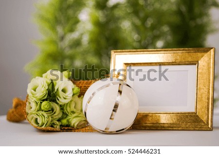 White flower with gold frame.
