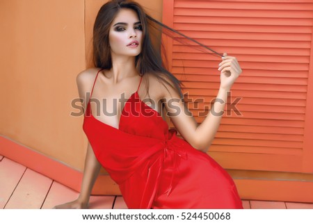 Only red,glam style girl,Lifestyle image,amazing skin,Copy space,Unusual Creative,Beautiful brunette young woman in red dress a,heathy girl,cosmetic,music,dreaming girl,Fashion Photo,toned,diamond