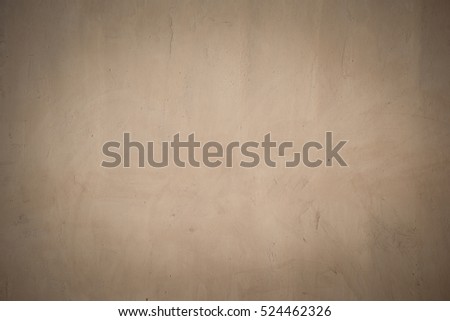 closeup surface detail of old beige-brown grunge stucco concrete wall with vignette effect, abstract rough texture for background or backdrop in architecture and structure concepts
