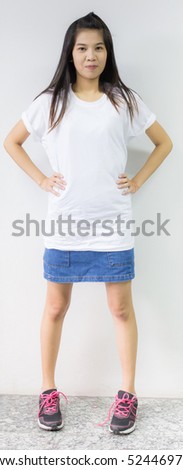 Portrait of young woman on white concrete wall