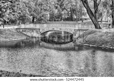 Pond and little bridge inside Mikhailovsky Garden, idillic park in central St. Petersburg, Russia