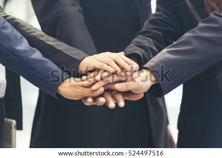 Happy Asian business working as teamwork to complete company mission & vision. Team corporate and integrity workforce helping leadership meeting in business. High five hand success agreement concept Royalty-Free Stock Photo #524497516