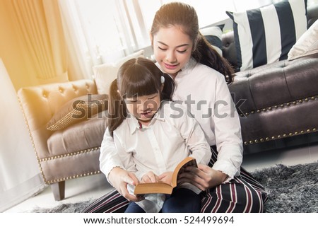  Mother Teaching children to do their homework at home,Asian family is happy
