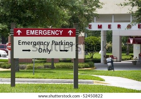 Hospital emergency entrance sign giving directions to emergency parking