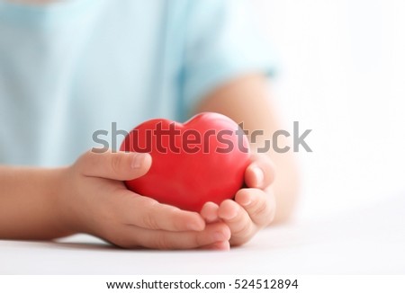 Little girl holding heart in her hands