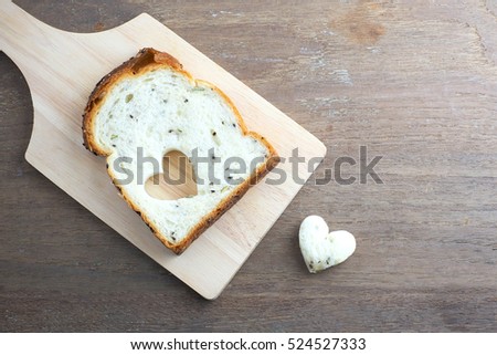 Bread of love, close up of sliced wholemeal bread on a wooden table.