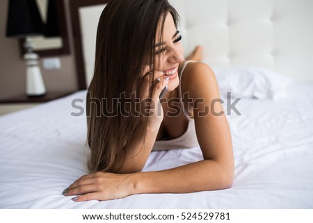 Beautiful girl speak phone in the bed