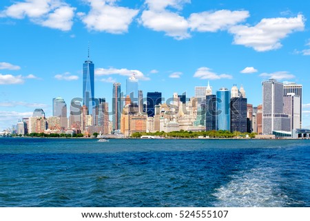 The Lower Manhattan skyline in New York City seen from the ocean on a sunny summer day
