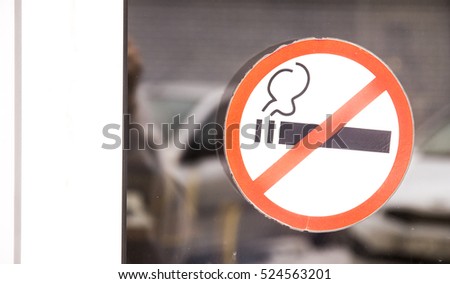 Prohibiting sign on the glass door to the shopping center no smoking
