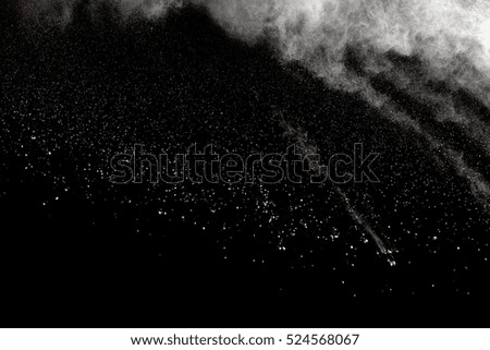 abstract powder splatted background,Freeze motion of white powder exploding/throwing white powder on black background.