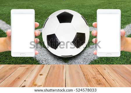 Man use mobile phone, image of football on field as background.