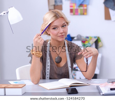 Young fashion designer working at studio.