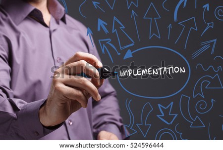 Technology, internet, business and marketing. Young business man writing word: implementation