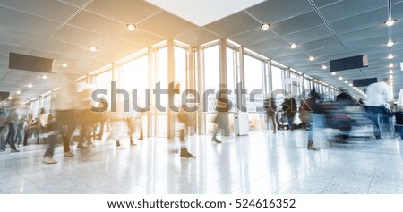 Blurred business people rushing at a corridor