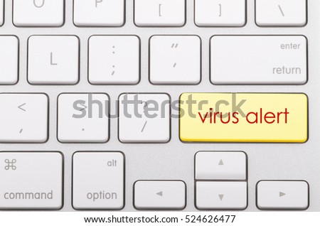 Virus alert word written on computer keyboard.   