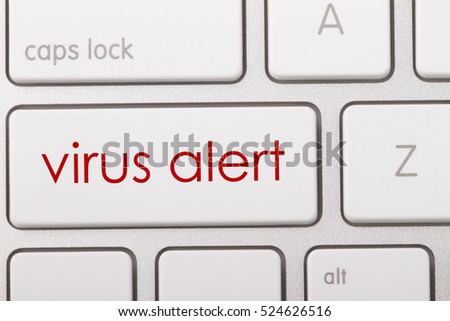 Virus alert word written on computer keyboard.   