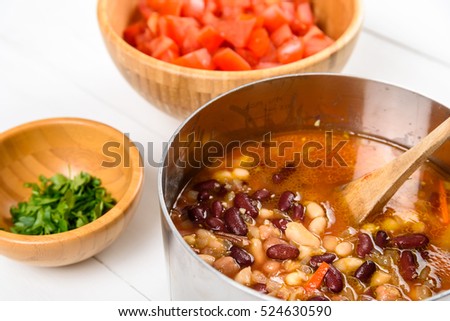 Preparing Chili Bean Stew On White Wood Kitchen Table