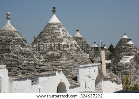 The conical roof of a trullo in Alberobello, Puglia, Italy, displaying magical symbols.