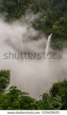 Nature landscape of waterfall in Laos.waterfall in mountain forest under great sky.Adventures and travel concept.Scenic landscape.beautiful place.wild nature.