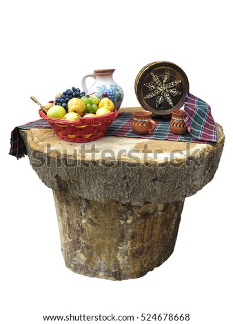 table made of logs with fruit basket and small wine barrel