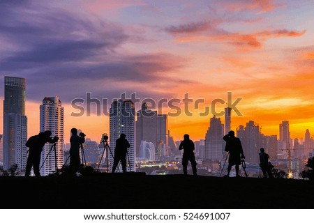 Silhouettes of many photographers. Beautiful sky and sunrise.