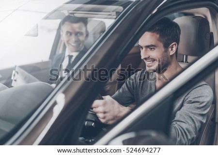 First test drive. Handsome young man ready to make first test drive Royalty-Free Stock Photo #524694277