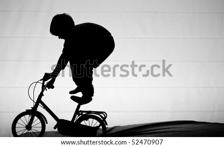 boy standing on bike