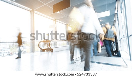 People in motion at a airport corridor