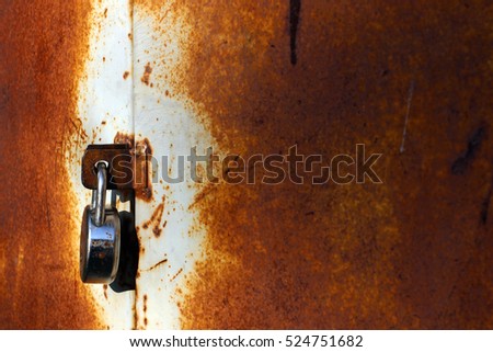 Steel Lock on a Closed Rusty Metal Door